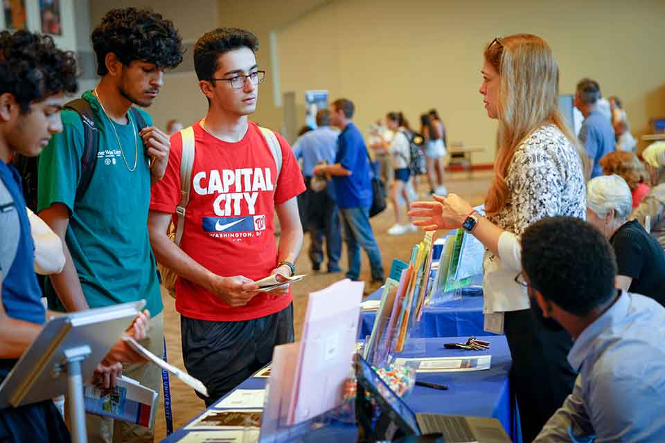 Academic Fair Students speak to an academic staff member during a SLU academic fair.