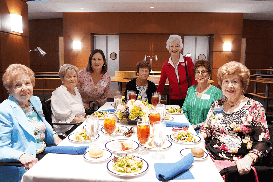 Spring Luncheon A group of women pose for a photo together at a table during the spring luncheon.
