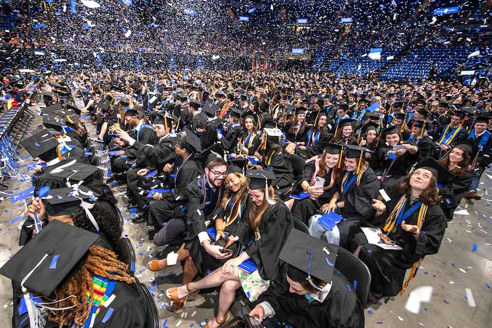 Graduation crowd A crowd of graduates in caps and gowns
