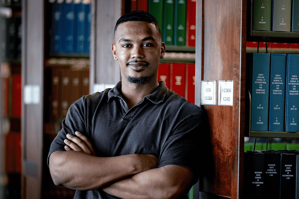 Jaylen poses for a photo in the law library.