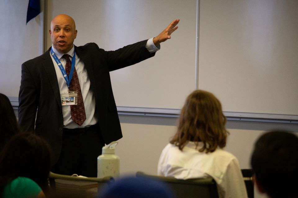 Professor Michael Duff teaches at the whiteboard in Scott Hall
