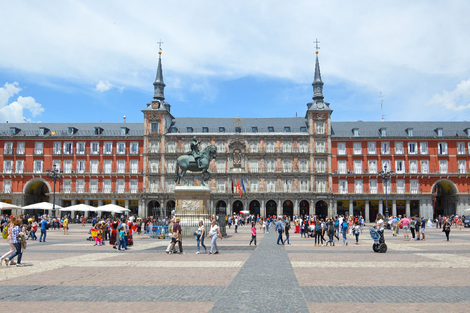 Madrid 2022 A photo of a crowd walking around Madrid's Plaza Mayor.