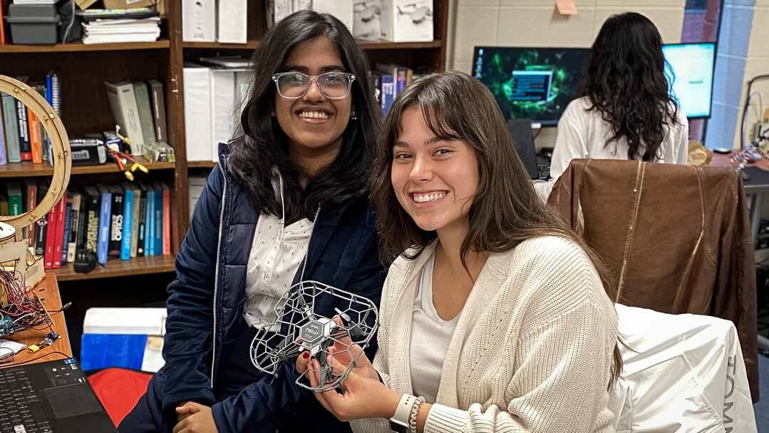 Two Aviation Lab students pose with their SURGE project.