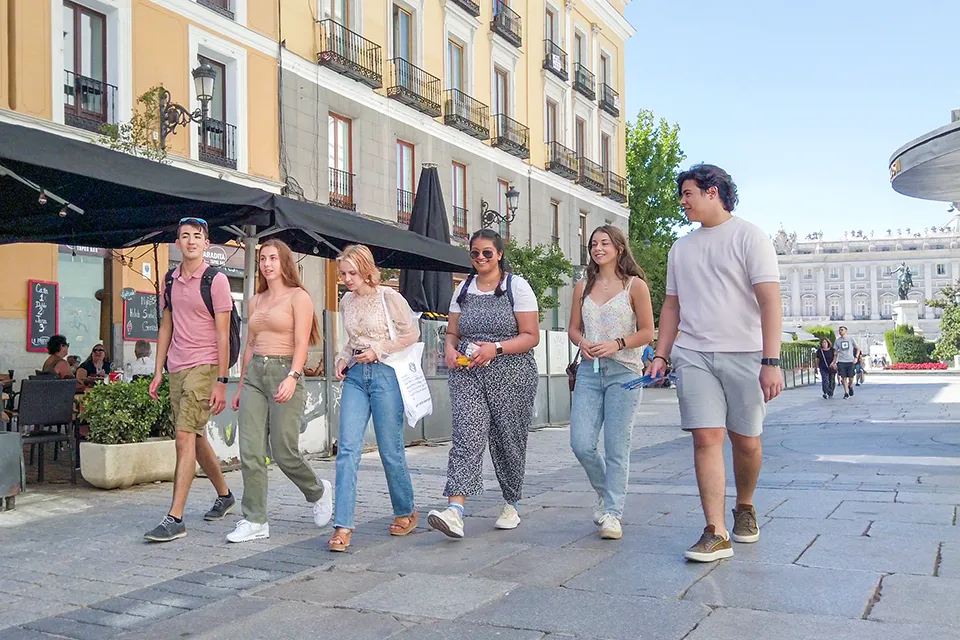 Students walking the streets of madrid close to the Royal Palace. Students walking the streets of madrid close to the Royal Palace.