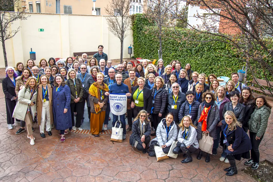 Attendees pose in the Padre Rubio Hall patio Attendees pose in the Padre Rubio Hall patio
