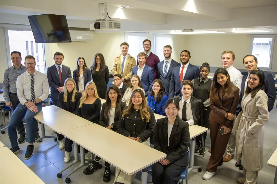 Brad Carlson, Ph.D. (seated on table in front) with OYMBA participants in a San Ignacio Hall classroom. Brad Carlson, Ph.D. (seated on table in front) with OYMBA participants in a San Ignacio Hall classroom.