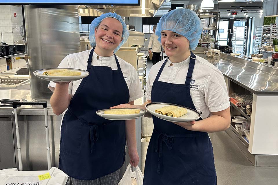 Senior students Hannah Bast and Anna Durfey clinched third place and a $1,000 prize for their innovative crepes filled with pesto chicken and roasted tomatoes. Submitted photo.&nbsp;