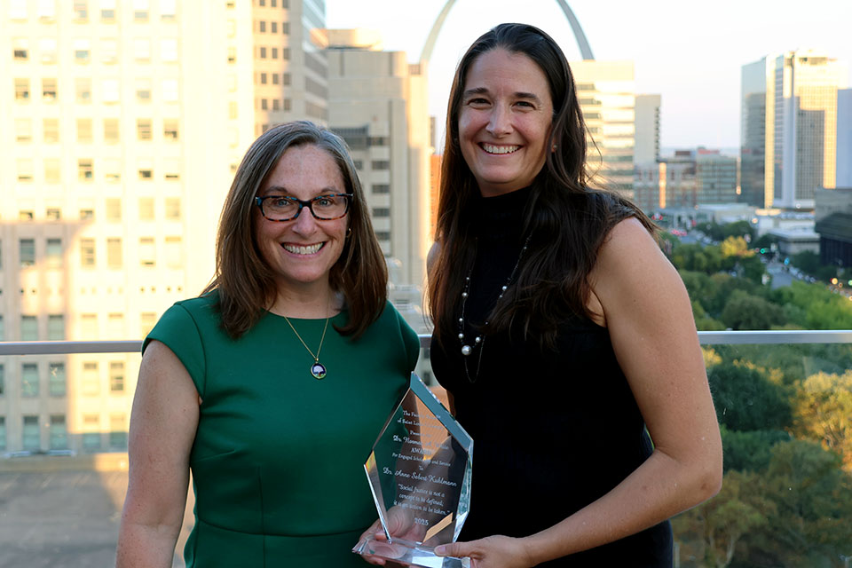 College for Public Health and Social Justice Dean Leslie McClure, Ph.D., left, and 2025 Dr. Norman White Award winner Anne Sebert Kuhlmann, Ph.D.