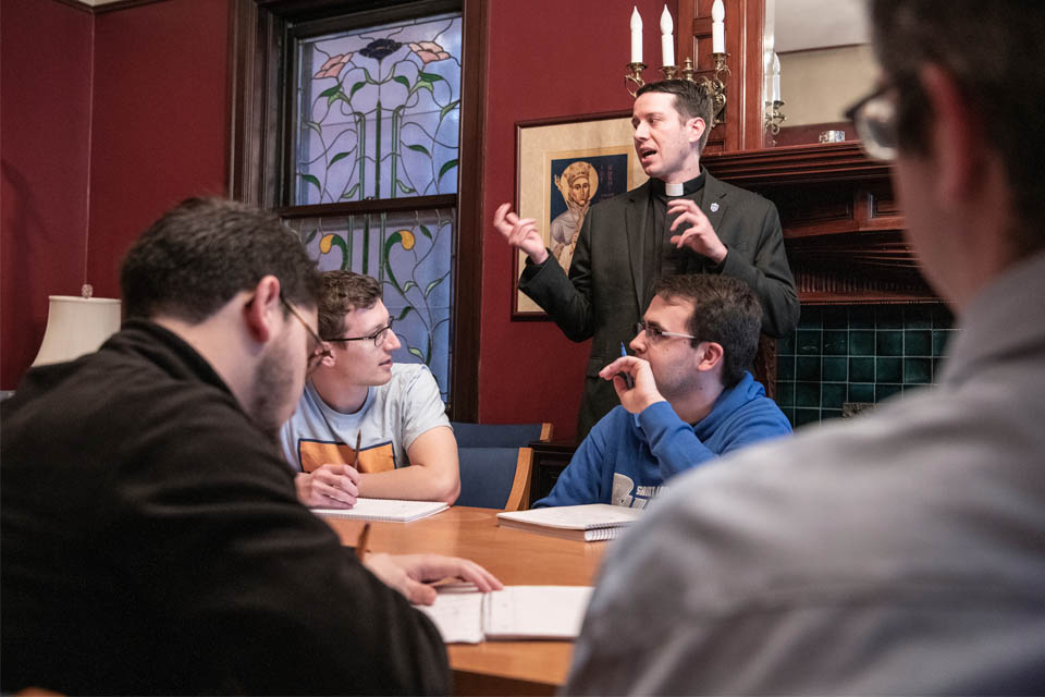 Fr. Rozier teaches a class Fr. Rozier teaches a class