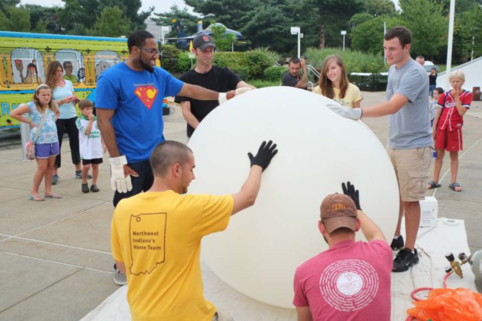 Ozone Balloons People crowded around a weather balloon that is ready to launch