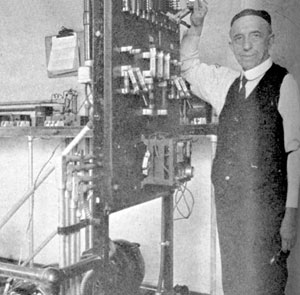 Brother George Ruepple, S.J., at his sending station in the early days of the radio. (1947)
