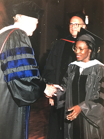 Anderson during her 2001 SLU commencement Anderson shakes hands at her 2001 SLU commencement.