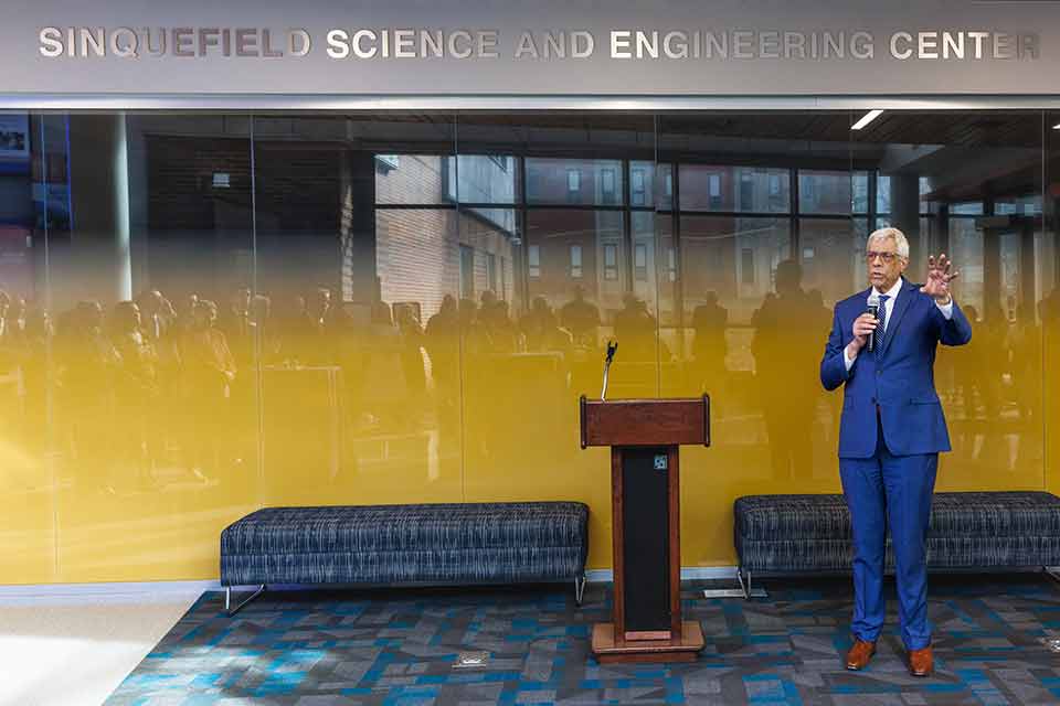 Fred Pestello, Ph.D., on stage speaking at an event.